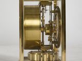 an image of a golden clock sitting on top of a white surface