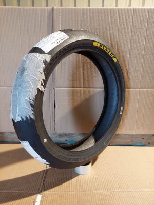 a tire that is sitting on the floor in front of a cardboard box