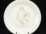 une assiette blanche sur laquelle est dessiné un coq