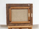 an old wooden easel with a canvas on top of it