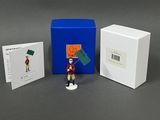 a figurine of a man holding a sign and a box