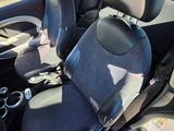 the interior of a small car with two seats and a steering wheel