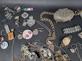 many different types of jewelry on a black surface