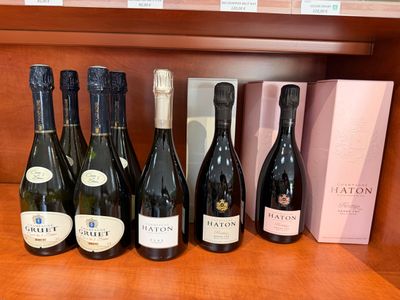Des bouteilles de vin sont alignées sur une étagère dans un magasin de vins.