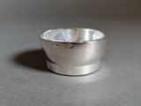 a small silver cup sitting on a table