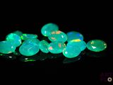 a close up of a bunch of green fire oplite stones