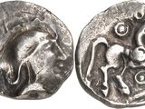 a close up of two silver coins on a white surface