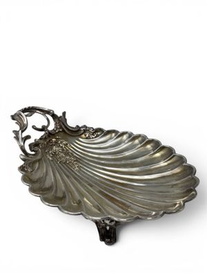 an image of a silver shell shaped dish on a white background