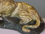 a statue of a lion that is sitting on a rock