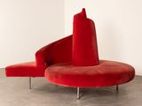 an image of a red chair sitting on top of a cement floor