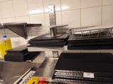 a lot of plates and pans on the counter in the kitchen
