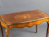 an image of a small table with a wooden top and gold trimming