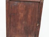 a small wooden cabinet with a door on it