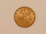 a close up of a gold coin with a woman ' s head on it