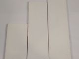 four pieces of white plastic are sitting on a white surface