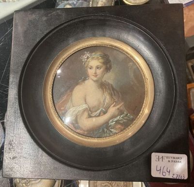 painting of a woman holding a baby in a black frame on a table