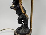 an image of a black and gold lamp with a statue on it
