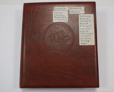 brown leather book with writing on it sitting on a white surface