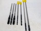 four different types of drill bits are laid out on a white surface