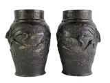 two vases that are sitting side by side on a white background