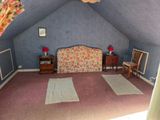 a room with a bed and a chair in it