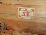 a wooden trunk with a label on it