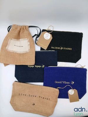 four small pouchs with tags and tags on them sitting on a table