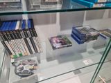 a lot of video games on display in a glass case