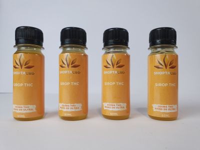 three bottles of honey syrup sit on a white surface