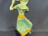 a statue of a woman with a flute in her hand