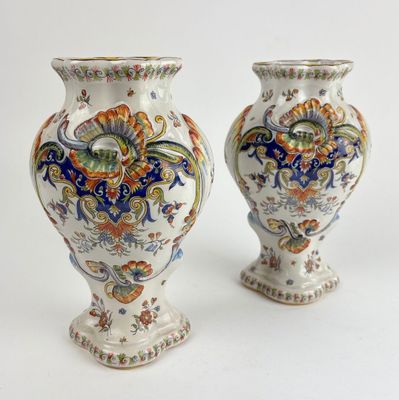 two vases sitting side by side on a white surface