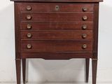an old wooden chest of drawers with brass pulls and drawers