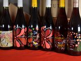 several bottles of wine are lined up on a table