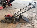 a lawn mower that is sitting on the ground