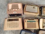 many old fashioned radio ' s sitting on the floor