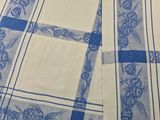 a close up of a blue and white table cloth on a table