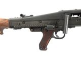 an old machine gun with a wooden handle on a white background