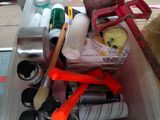 a plastic container filled with assorted items on the floor
