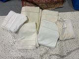 four pairs of knee pads sitting on a table