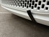 a close up of a white car with a sticker on it ' s bumper