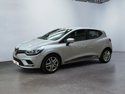 a silver car is parked in a large room with white walls
