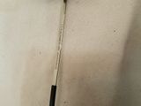 a close up of a golf club on a white cloth