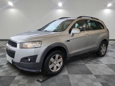 the silver suv is parked on a checkered floor in a garage