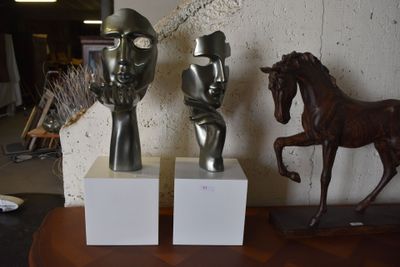 two statues of a man and a horse on a table