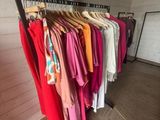 clothes are hanging on a rack in a clothing store
