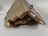 an open book on a white surface with a ring on it