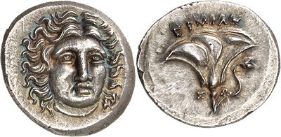 a close up of a coin with a face on it