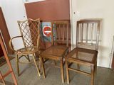 three wooden chairs sitting next to each other in a room