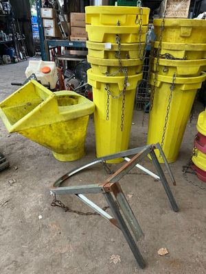 many yellow buckets sitting on the ground next to a red fire hydrant