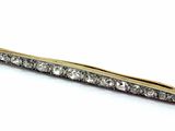 an image of a gold and diamond hair clip on a white background